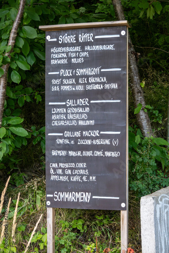 Photography Stockholm, Sweden  A blackboard restaurant summer menu in Swedish offers salads, burgers, and grilled sandwiches