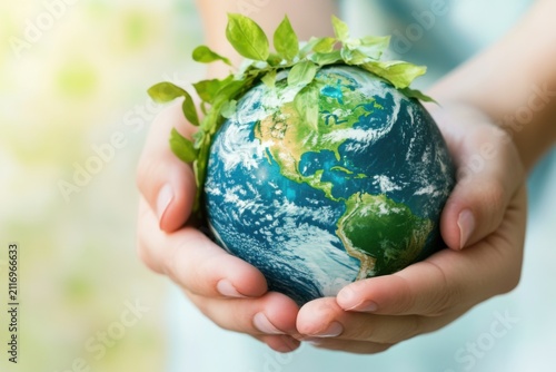 Hands Holding Earth with Green Leaves
