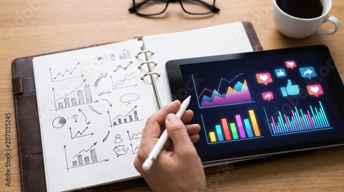Business analytics and data visualization on tablet and notebook.