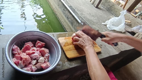 Professional Video Footage of Butcher Carefully Cutting Fresh Raw Meat on a Wooden Cutting Board for Culinary Preparation and Food Industry Concept