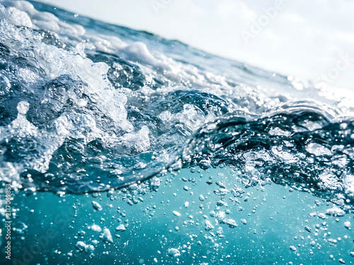 Dynamic Blue Ocean Water Waves with Turbulent Currents, Flowing Bubbles, Liquid Motion, and Refreshing Abstract Nature Background.
