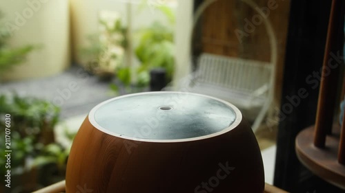 Wood Grain Aroma Diffuser Releasing Steam by a Window