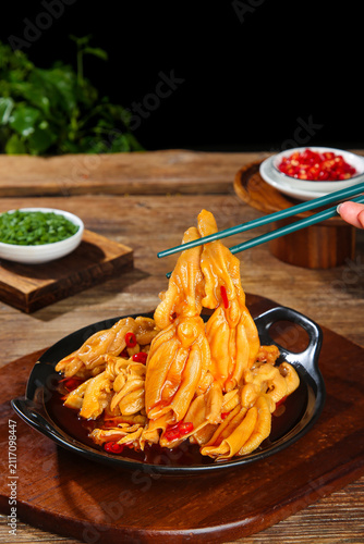 Spicy braised chicken feet with chili and chopsticks