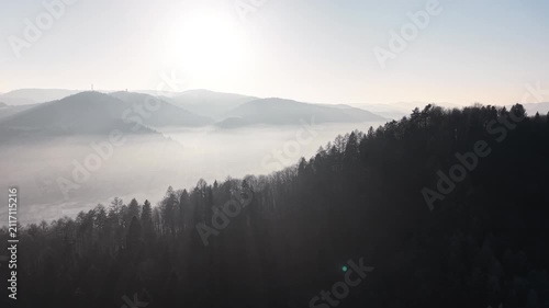 Beautiful foggy hills with soft morning sunlight
