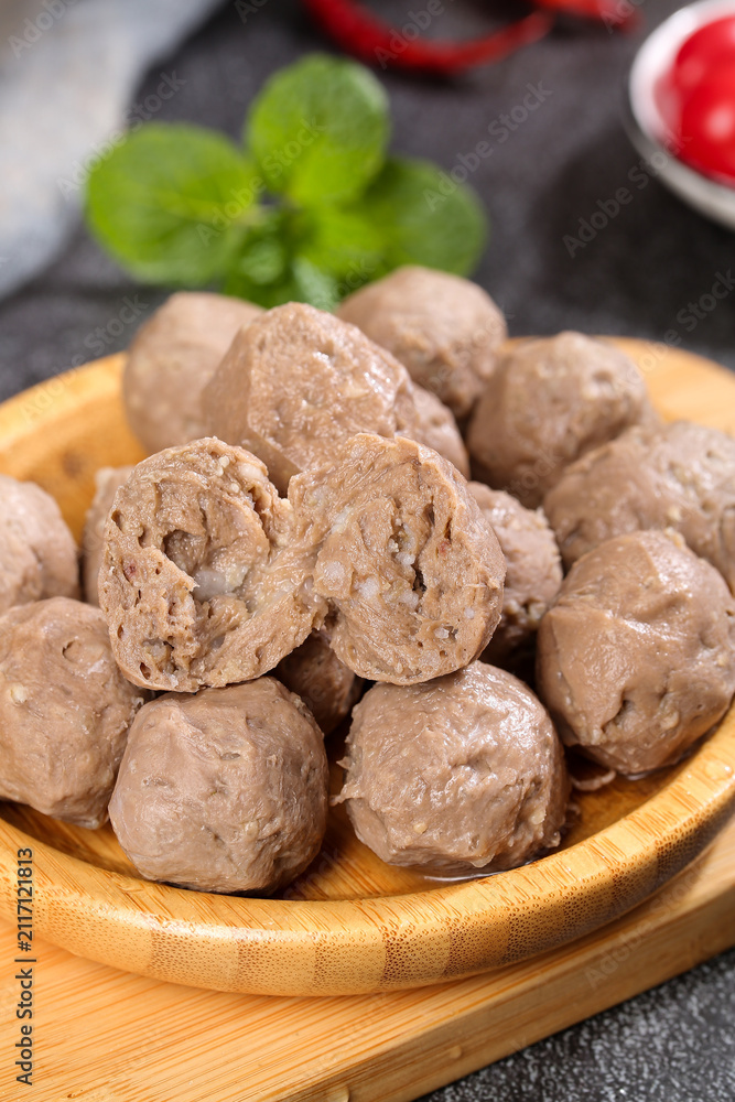Fototapeta premium Handmade Chaoshan Beef Tendon Meatballs Traditional Chinese Food in Wooden Bowl Studio Shot