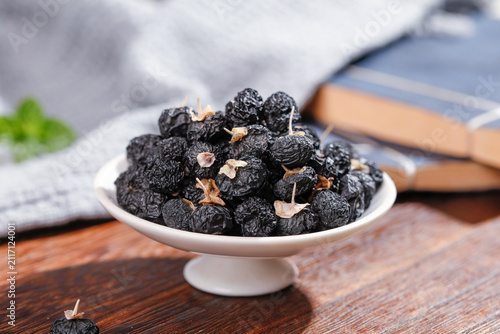 Quadro su tela Dried Black Goji Berries from Qinghai in White Bowl Studio Still Life Food Photo