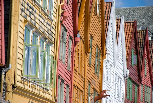View along facade of colorful hanseatic wooden houses of landmark Bergen Bryggen in Norway