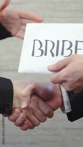 Handshake and giving the bribe envelope in slow motion