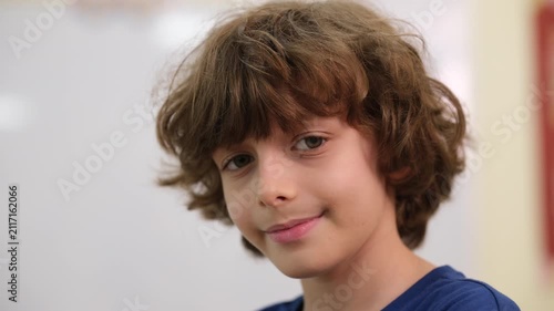 Portrait of a boy looking at the camera and smiling.