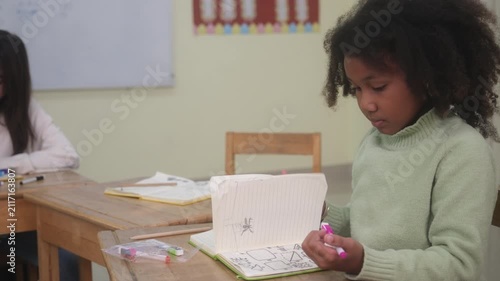 The teacher is teaching the students in the classroom.
