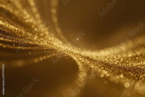 Golden glowing particles floating through soft light creating a luxurious abstract background