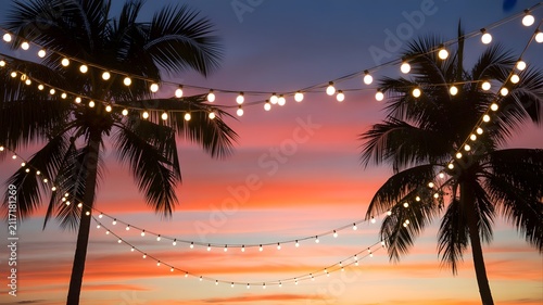 Beautiful tropical beach sunset with string lights perfect for a relaxing summer bank holiday weekend getaway