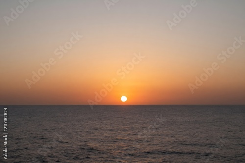 Sunrise over ocean horizon with warm natural colors