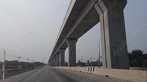 Driving in highway and elevated railway. Lopburi Province, Thailand.