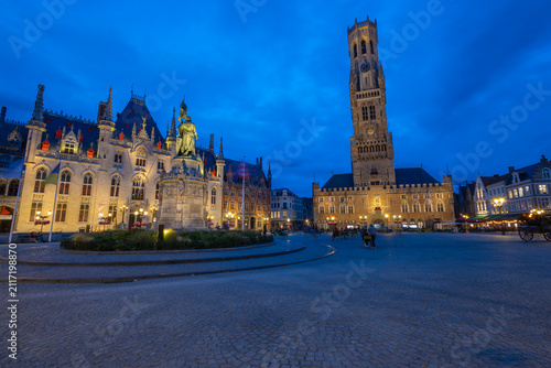 BRUGES, BELGIUM, JULY 14, 2025 - The Market Square (Markt) in Bruges, Belgium, at the blue hour. The Provincial Court is in the center of the view. On the right stands the famous Belfry.
