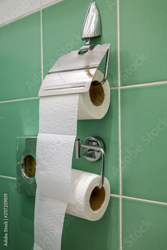 Double roll toilet paper holder with chrome finish.