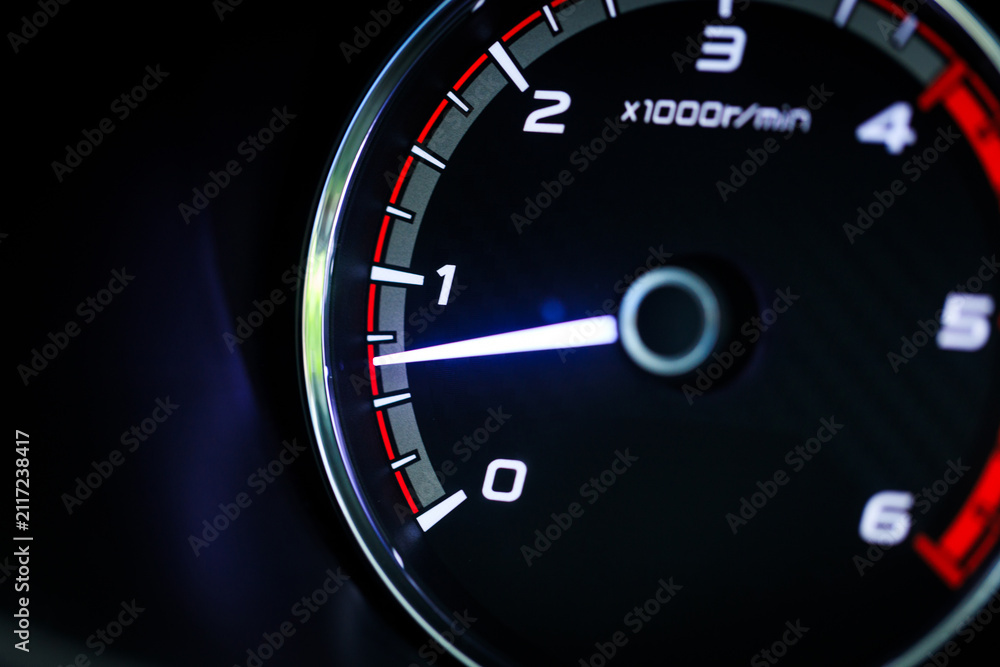 Fototapeta premium Close-up of a diesel truck's dashboard and tachometer. It represents the power and durability of a work vehicle, with a clear focus on the round engine meters.