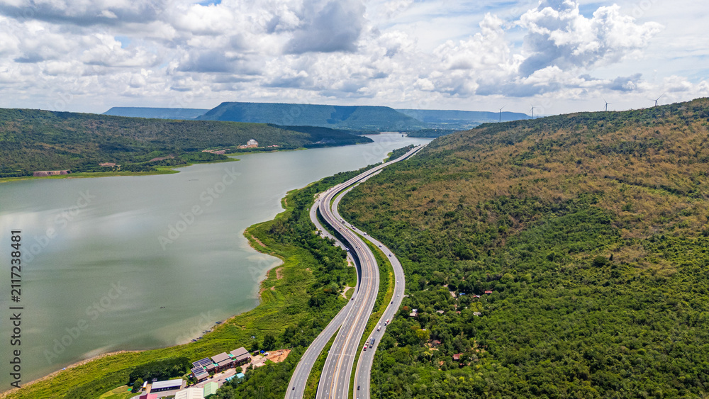 Fototapeta premium Drone shot The M6 motorway Nakhon Ratchasima Province - Bang Pa-in Lam Ta Khong River and Mountain. Motorway Korat Thailand