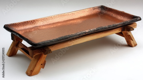 A wooden tray with a copper finish.
