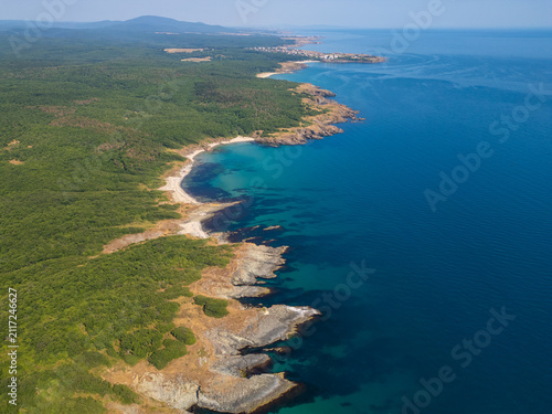 Aerial Top-Down View of Rocky Coastline and Deep Blue Sea Water