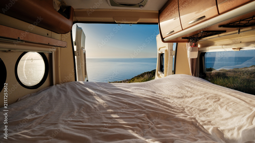 Obraz premium Breathtaking view from a cozy camper van overlooking the tranquil sea in Chalkidiki, Greece