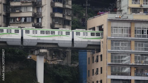 train enters liziba station inside a building on bridge in Chongqing china