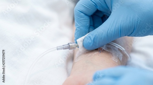 Sanitized Fingertips Approaching an Intravenous Line Connection Point – Close-Up Detail, Hospital Hand Hygiene & Infection Control Concept