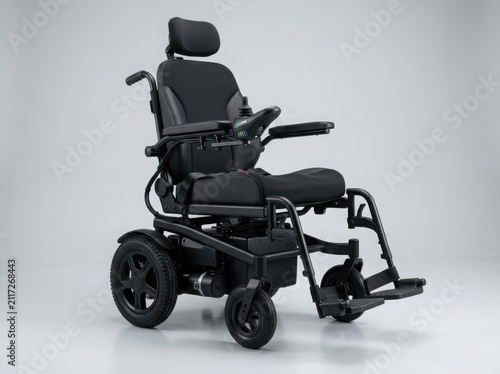 Modern black electric wheelchair with comfortable padded seat and joystick controller for disabled people or senior mobility