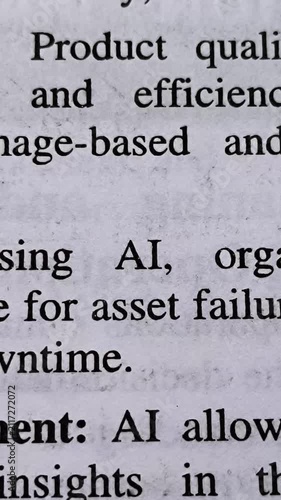 AI (artificial intelligence) word printed on news articles, books or magazine white page background. AI technology growth, hype, boom or concern concept. Closeup of emphasize and highlight AI text.