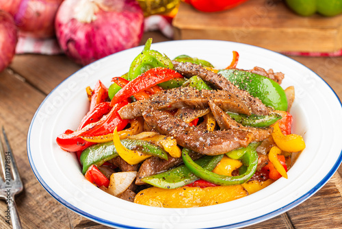 A plate of fried beef cubes with green pepper