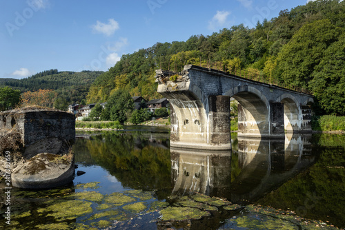 Le Pont Cassé, also known as the broken bridge at Bohan-sur-Semois, in the Namur Province of Belgium. Captured on a sunny summer morning with blue sky, and copy space.
