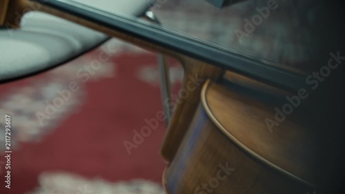 Close up of a beautiful violin resting against a chair, classical music, 4k