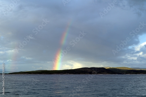 Rainbow over the sea after rain