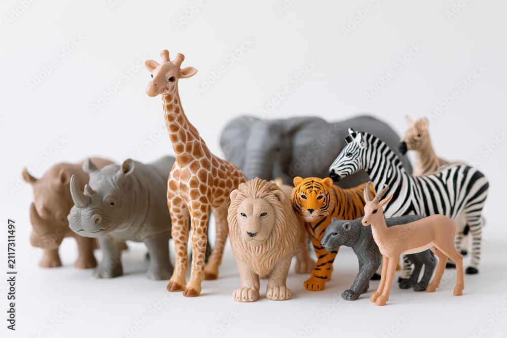 Obraz premium The lineup of toy animal figurines in a bright white studio