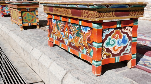 Traditional hand-painted Tibetan wooden tables with dragon motifs in Leh, Ladakh, India