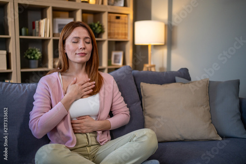 Woman practicing mindful breathing for relaxation and stress relief at home