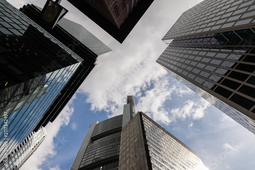 FRANKFURT, GERMANY - APRIL 4, 2026: A wide-angle vertical perspective looking up at the high-rise office towers of Germany's financial capital