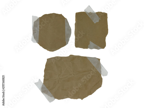 Three brown craft paper scraps with adhesive tape pieces
