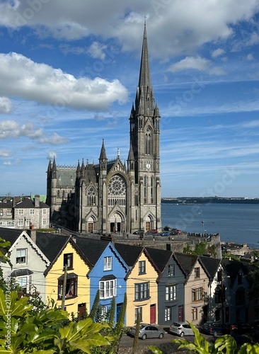 St. Colman's Cathedral overlooking colorful houses in Cobh harbor, County Cork, Ireland, July 2025