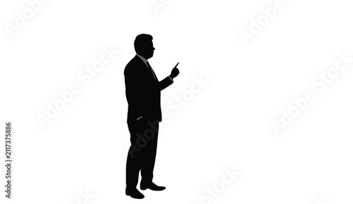 Businessman wearing a formal suit stands in profile pointing a finger to indicate a direction or choice for strategic business presentations that require a clean design with white copy space area.