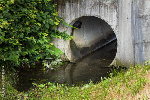 concrete drainage culvert with flowing water