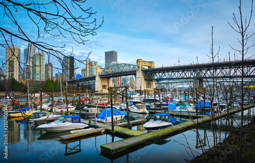 Scenic view of motorboats moored in a marina by the Burrard Street Bridge across False Creek, Vancouver, British Columbia, Canada.
