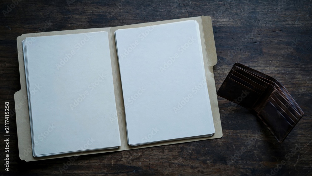 Fototapeta premium Open Blank Photo Album with Wallet on Wooden Table.