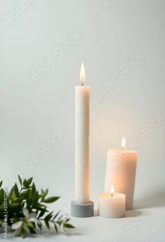 Three white burning candles...