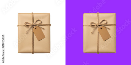 A rustic brown paper gift box tied with twine string and a blank cardboard tag on top view transparent png