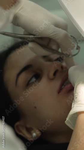 Orthodontist performing braces treatment on a patient
