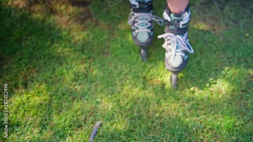 A Young Roller Skater Prepares to Glide Across the Grass in Colorful Roller Skates, Showcasing Focus and Excitement for the Fun Ahead in the Great Outdoors