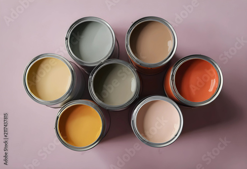 Seven open paint cans with ...
