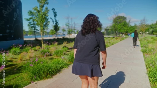 A Serene Walk Through a Lush Park: Exploring Nature and Tranquility on a Beautiful Day as People Enjoy the Scenic Pathway and Vibrant Surroundings