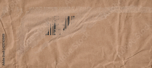 Frame made of brown beige old vintage paper with damaged barcode, crumpled wr...